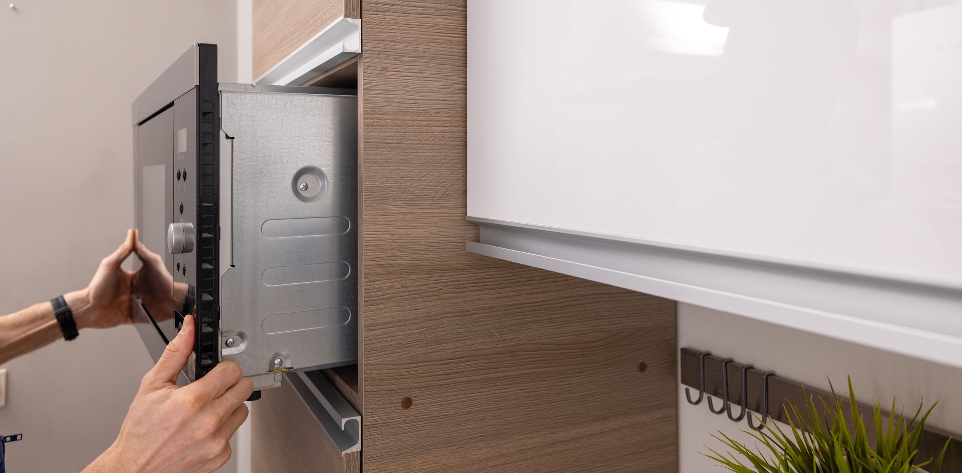 Integrated microwave oven installation in the domestic kitchen.