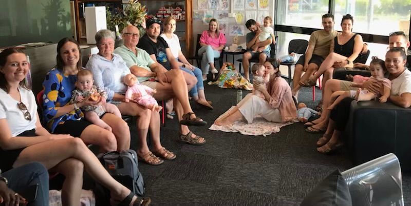 Adults sitting around in group
