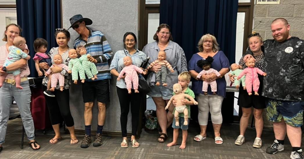 People standing with babies and children