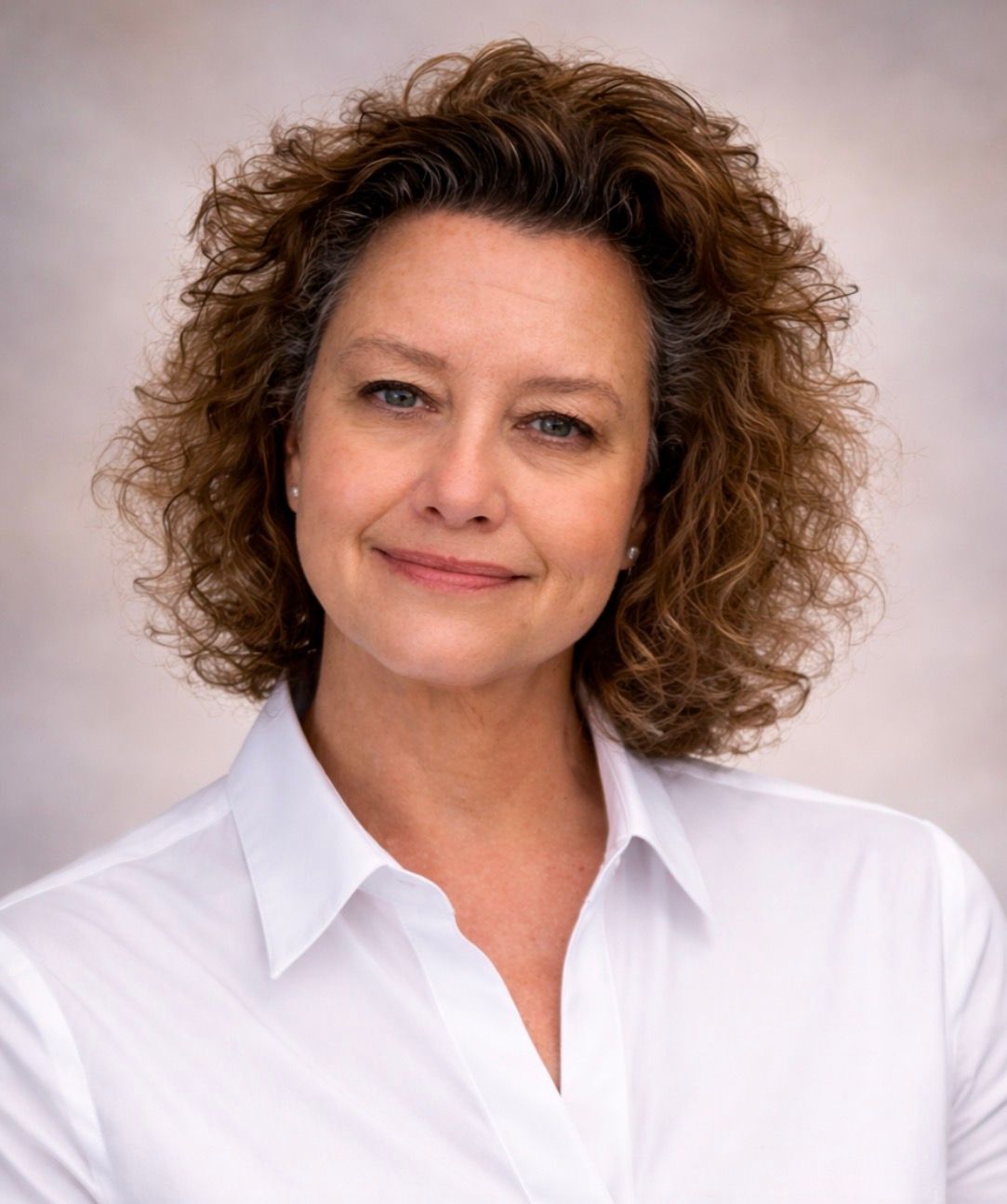 A woman wearing sunglasses is taking a selfie at a dock.