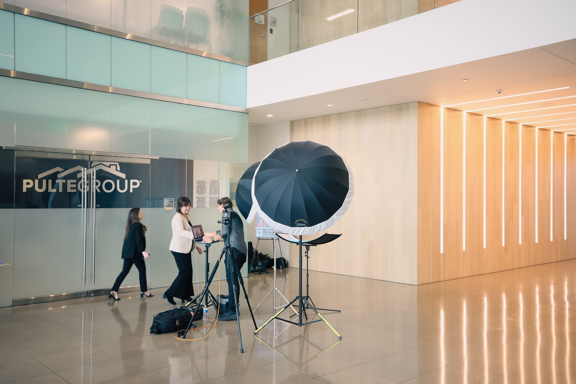 A group of people are standing in a lobby of a building.
