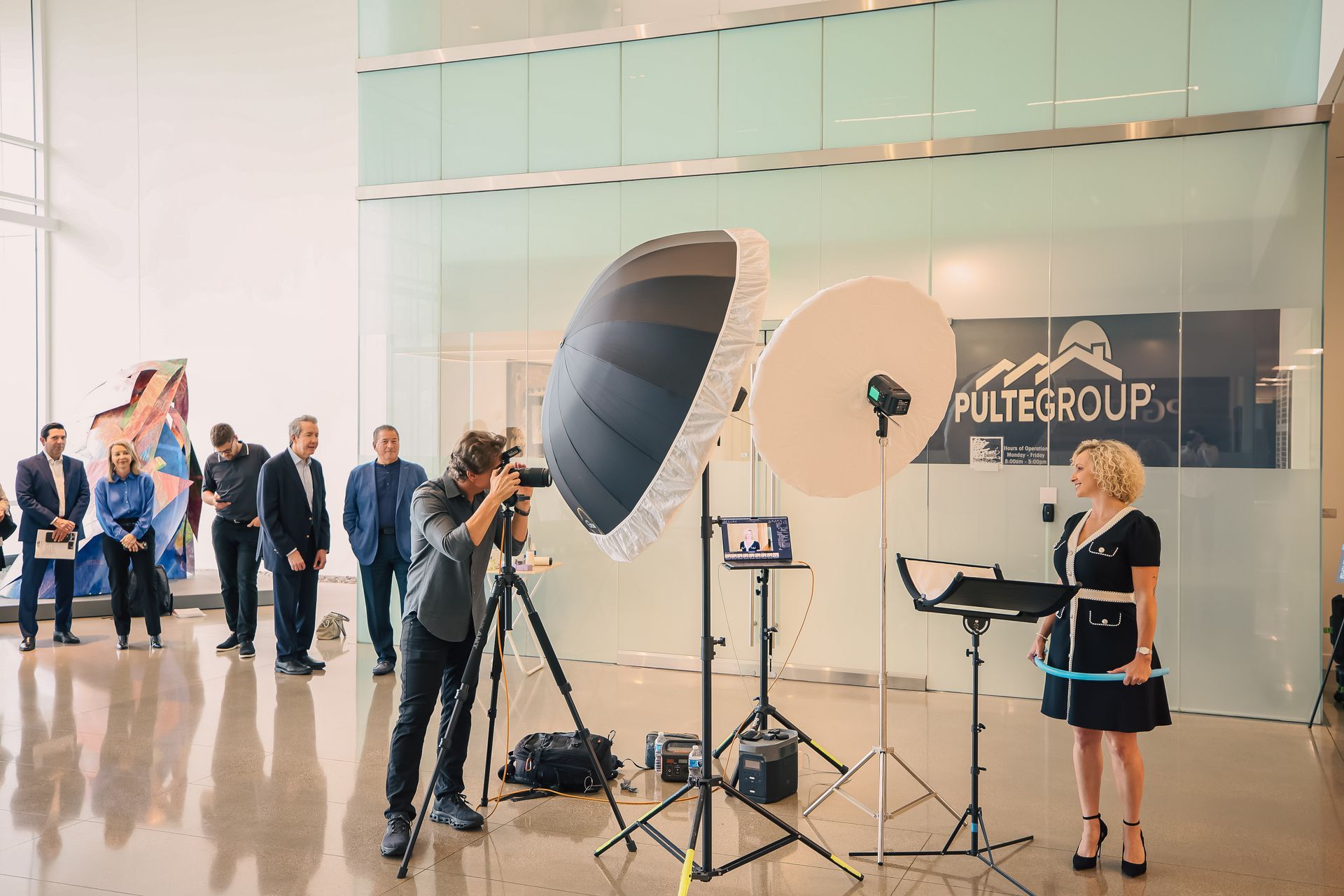 A man is taking a picture of a woman in a room.