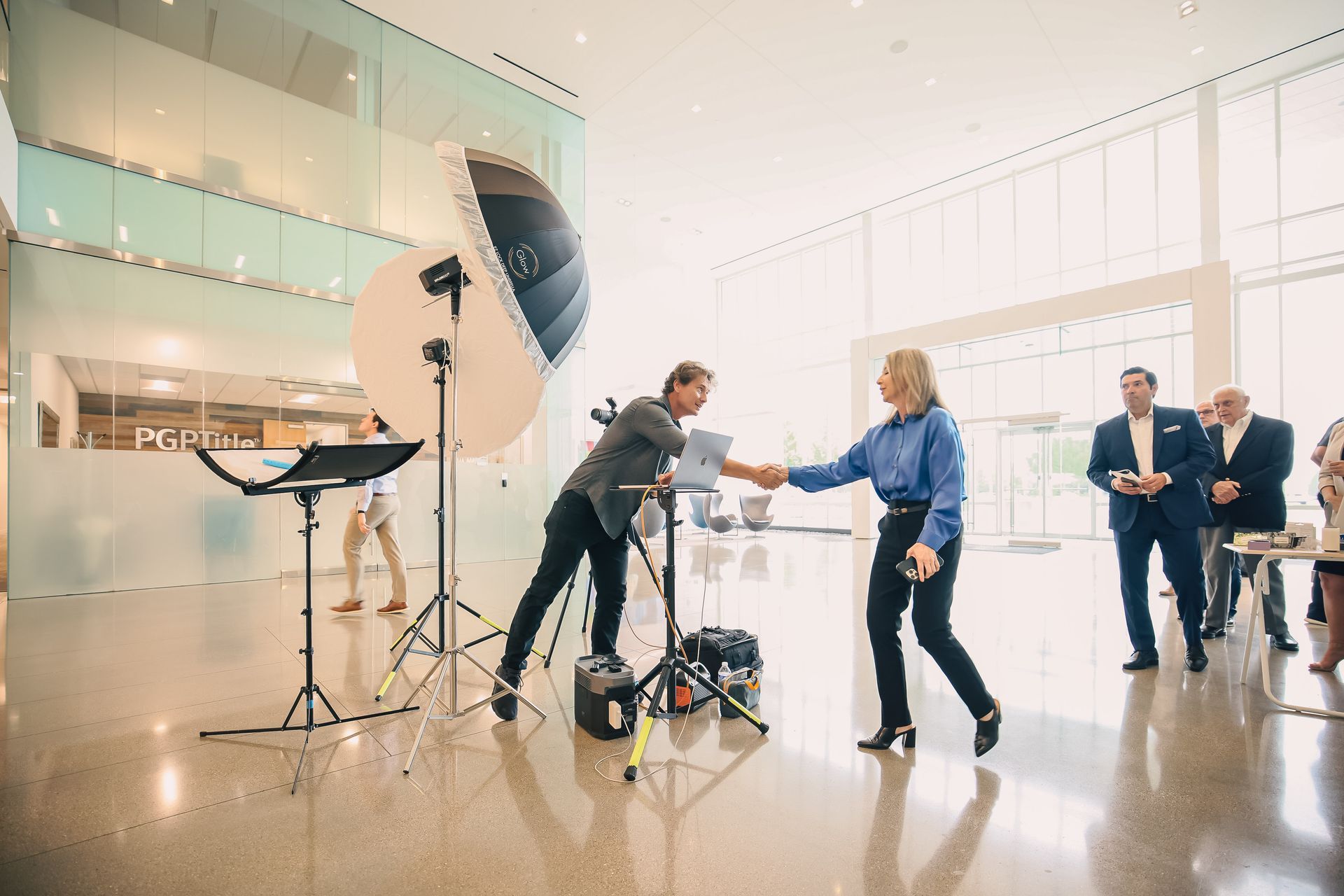 A man is shaking hands with a woman in a room.