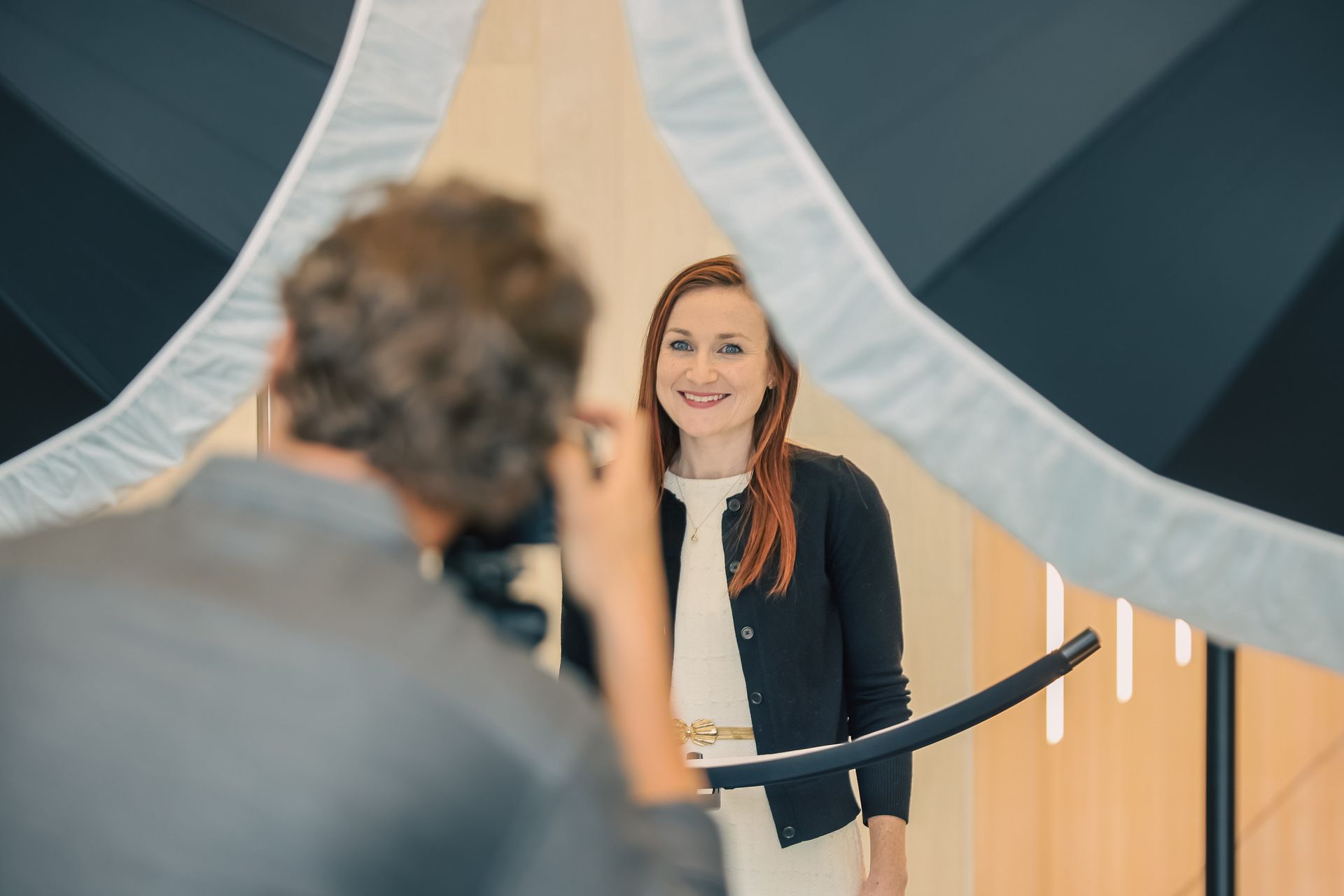 A man is taking a picture of a woman in a photo booth.