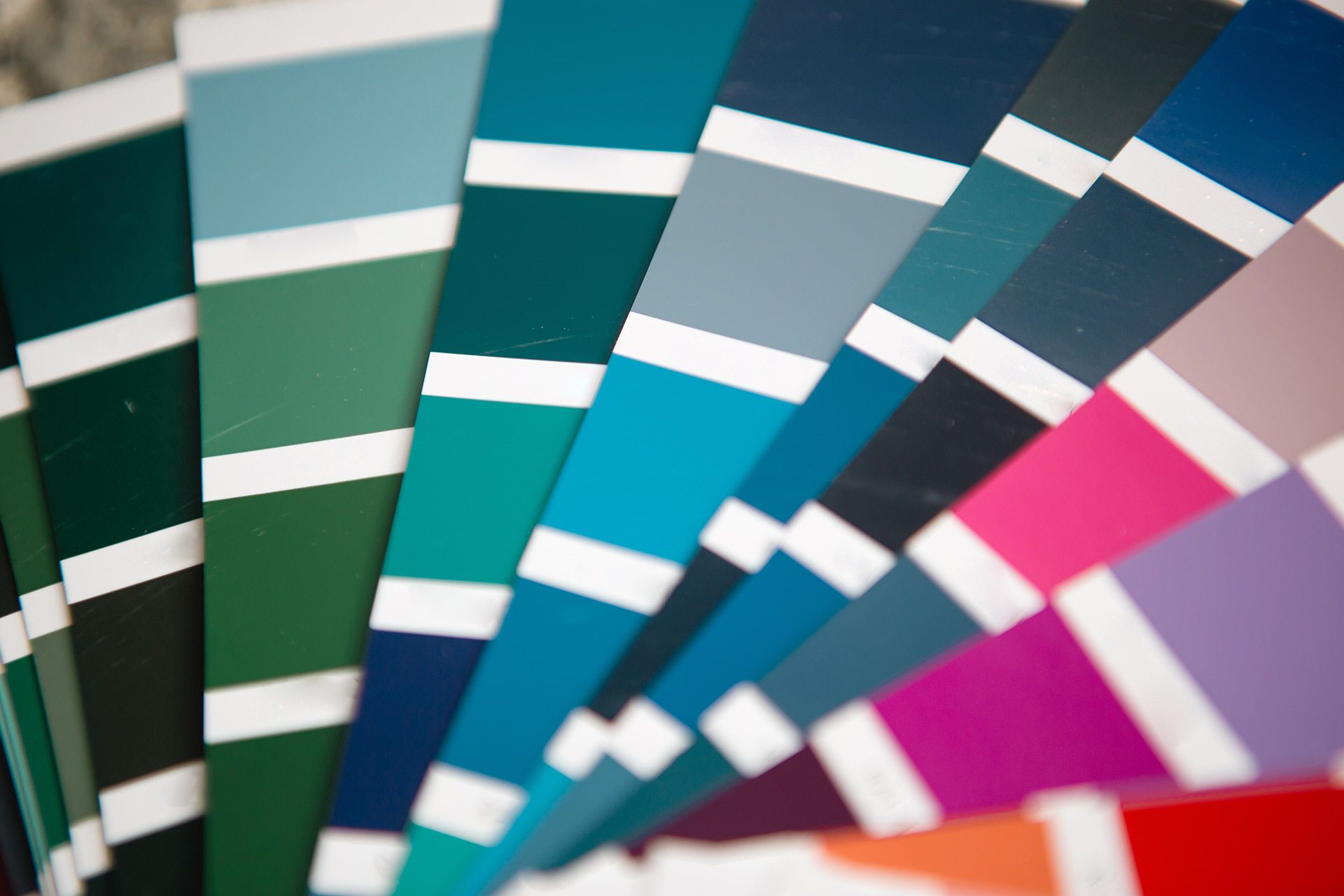 Fan of color swatches in teal, blue, magenta, and red with white divider strips