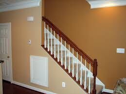 Staircase with white railing against tan wall in a home interior