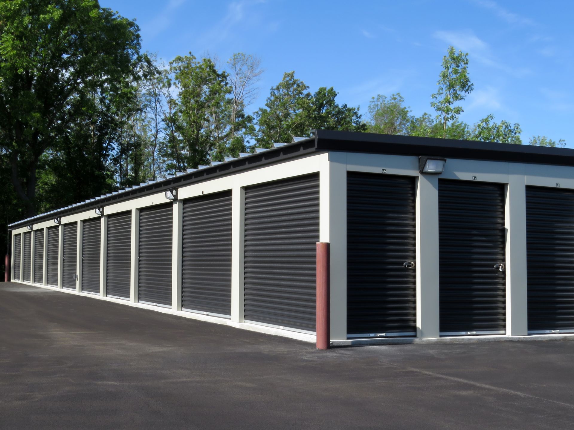 Self storage units with black garage doors.