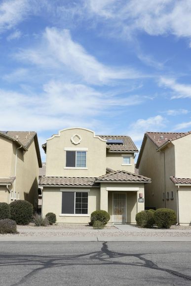 A row of houses with a blue sky in the background