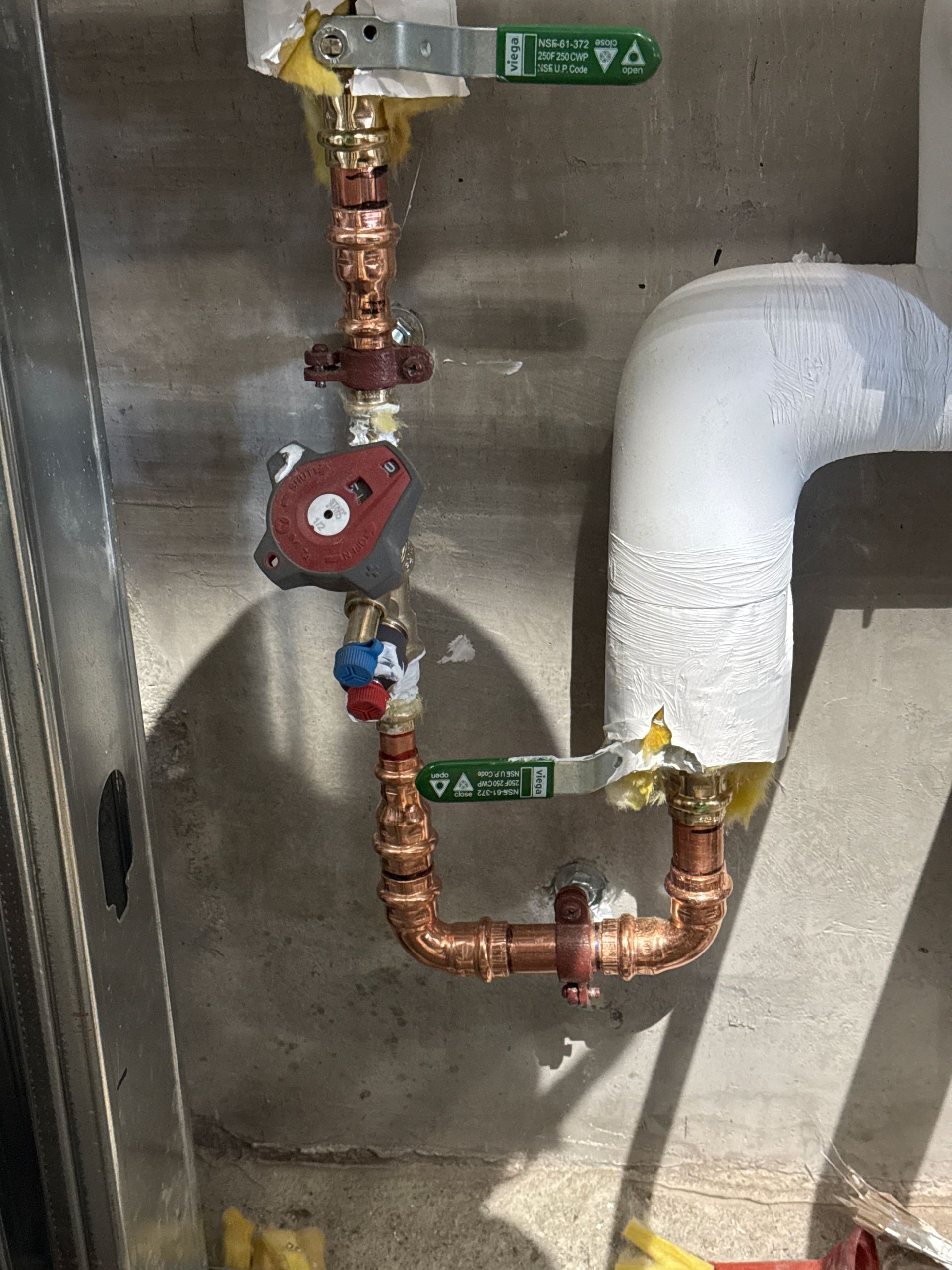A patio with a table and chairs and an umbrella in front of a house