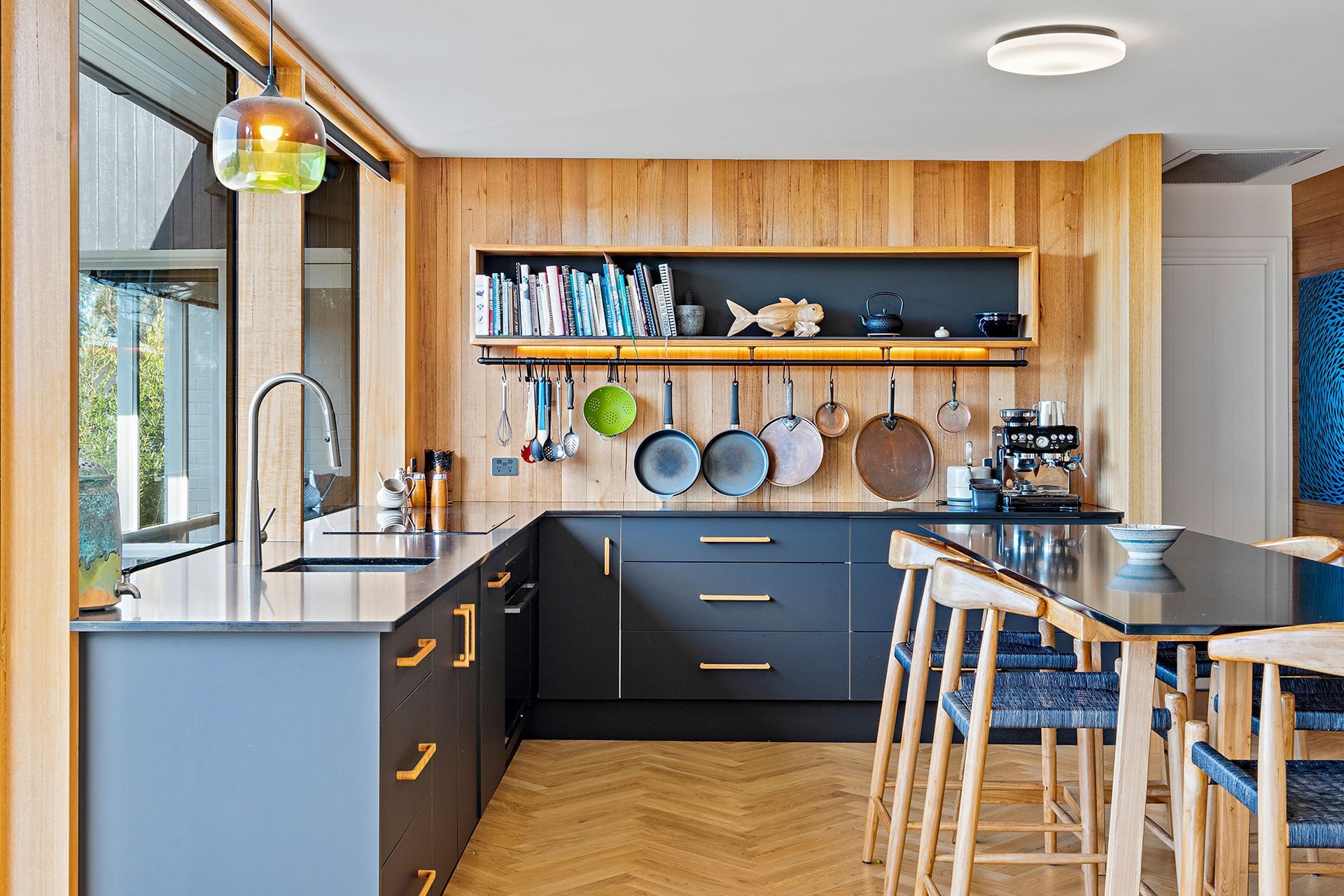 A kitchen with a table and chairs and a sink.