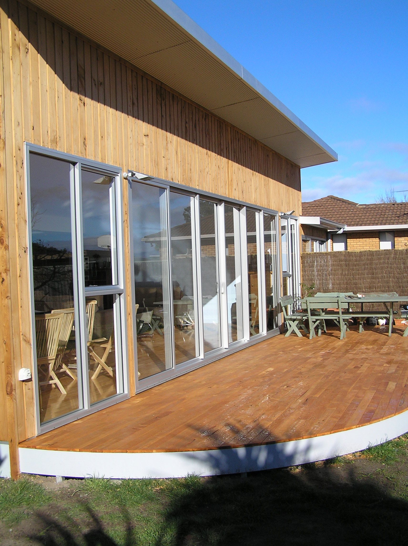 A house with a large deck and lots of windows