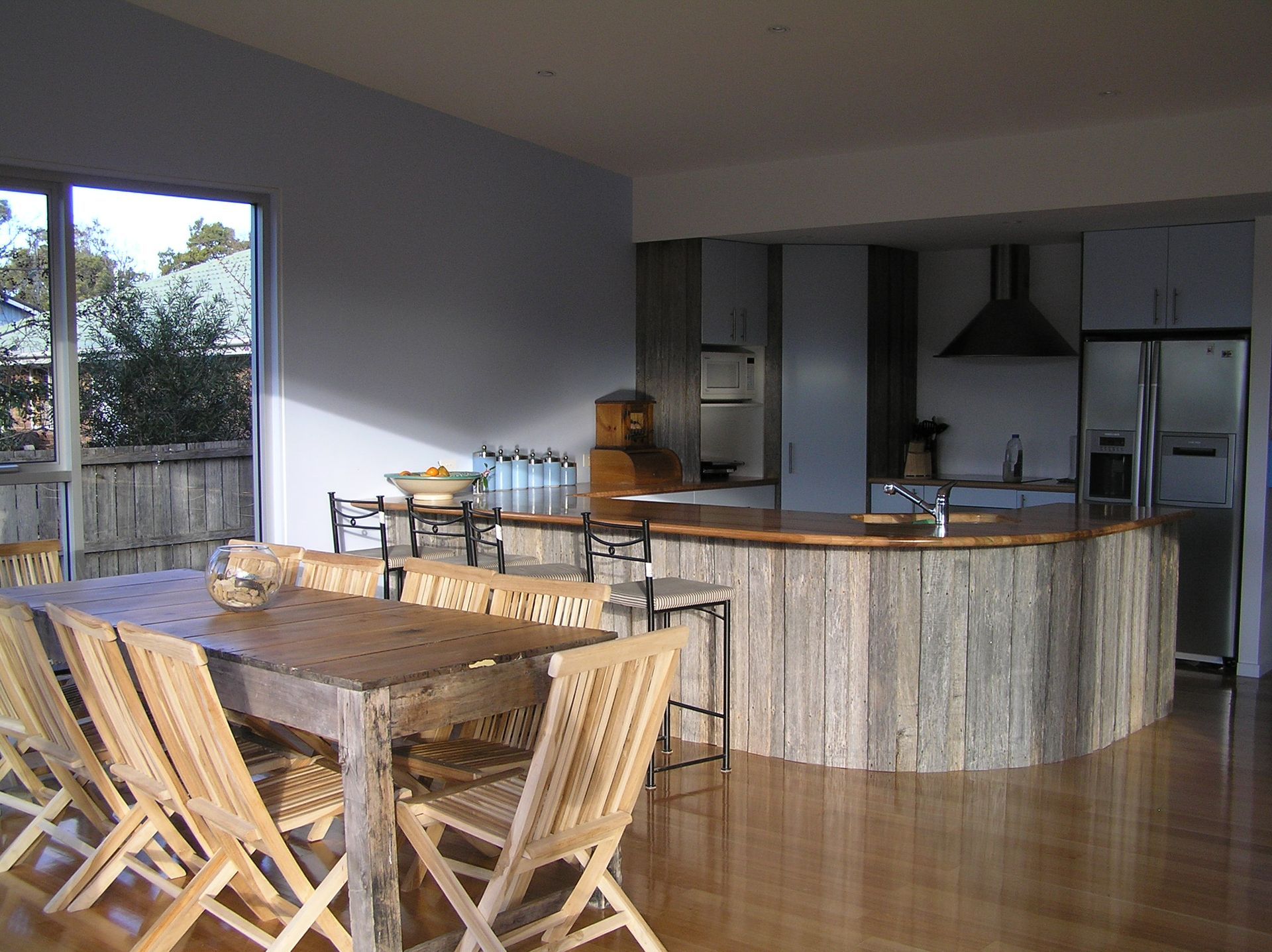 A kitchen with a wooden table and chairs
