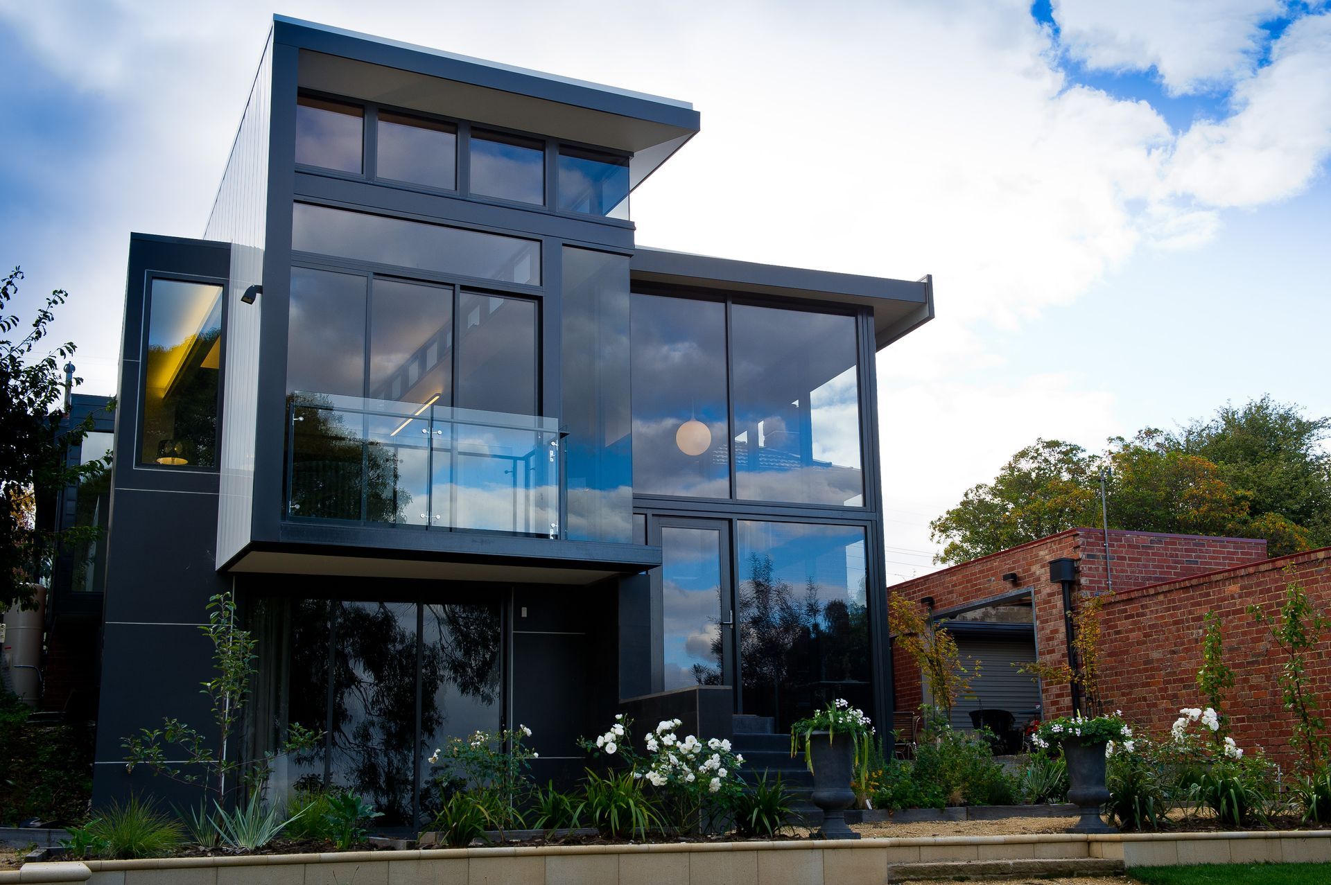 A modern house with a lot of windows and a balcony
