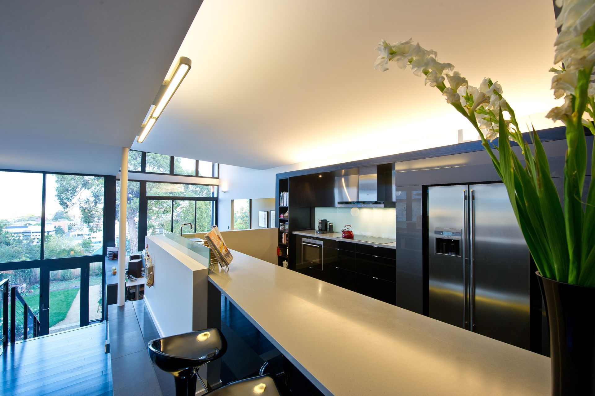 A kitchen with a vase of flowers on the counter
