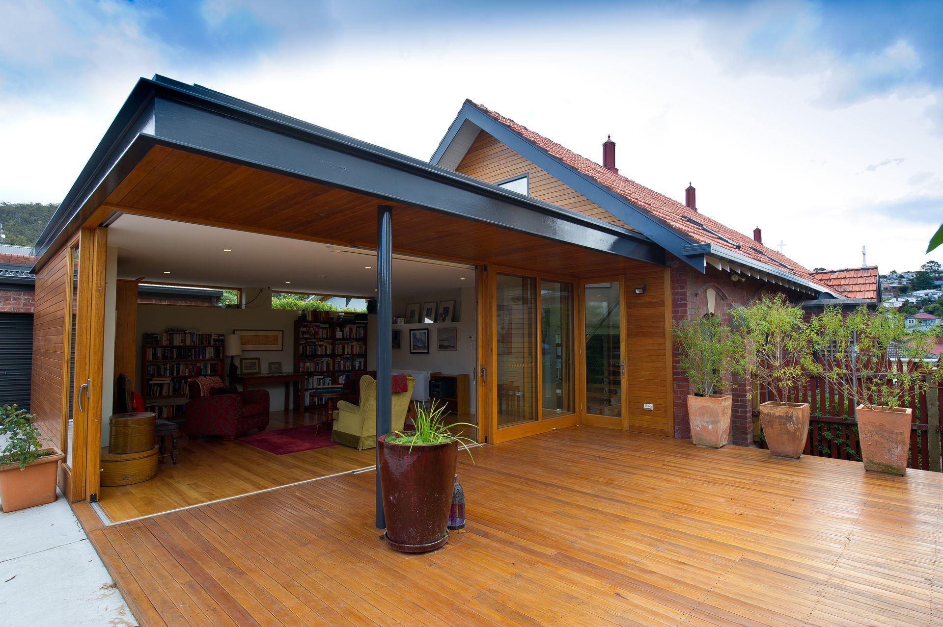 A house with a large wooden deck in front of it