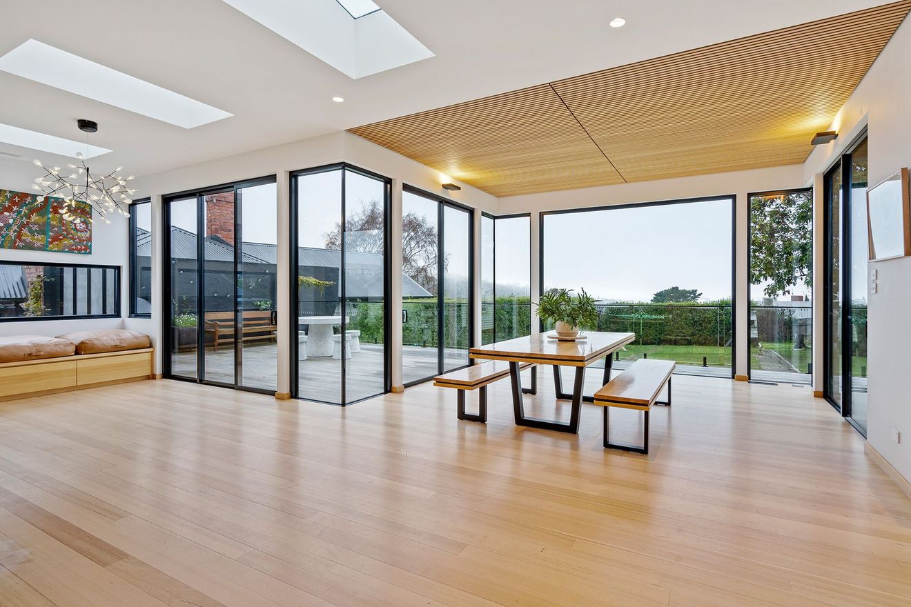 A large room with a table and benches in it.