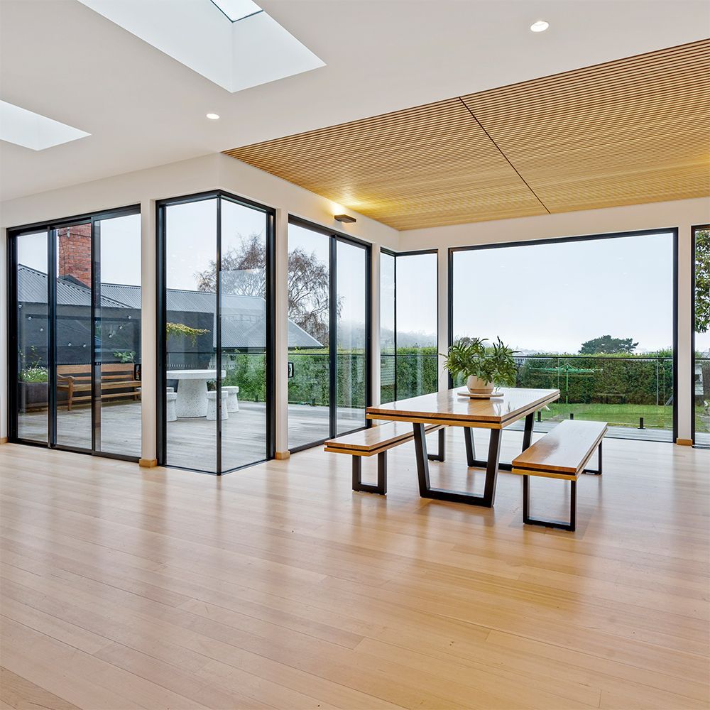 A large room with a table and benches in it.