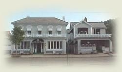 Two houses are sitting next to each other on a street.