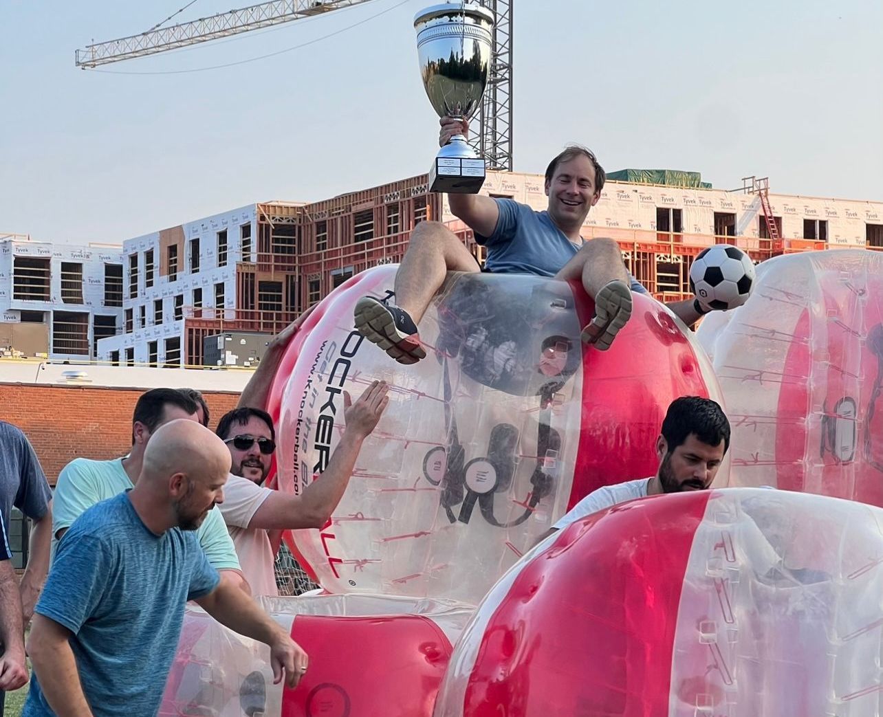 An aerial view of an inflatable soccer field in front of a building.