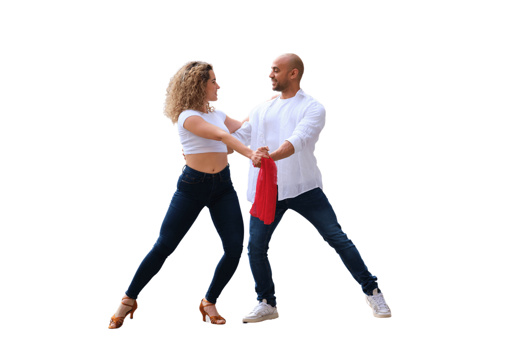 Couple dancing Salsa, holding hands, red scarf, woman in crop top, man in white shirt, jeans.