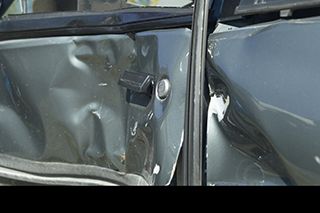 gray car door with large dent Greensboro, NC