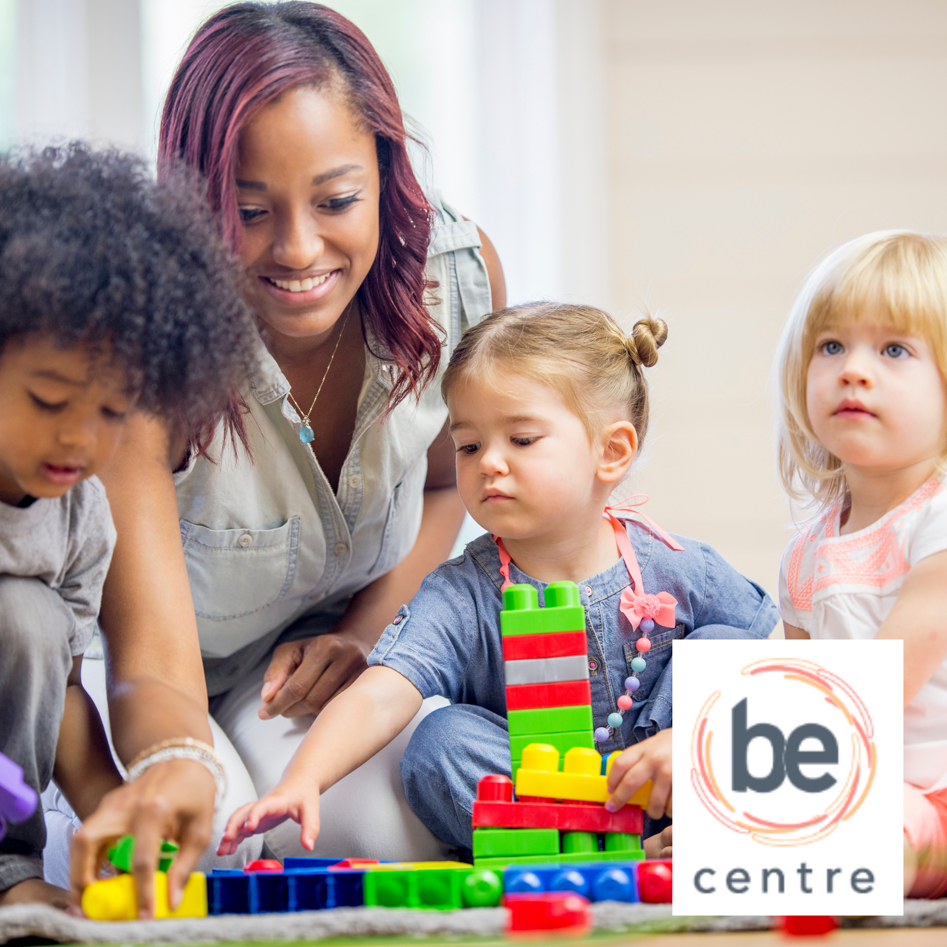 Woman playing with children using legos.