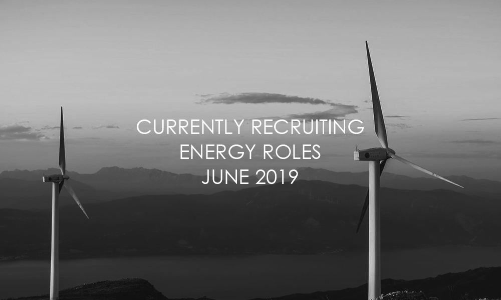 A black and white photo of two wind turbines with the words currently recruiting energy roles june 2019.