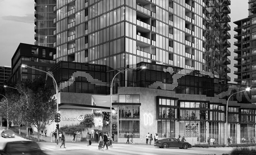 A black and white photo of a city street with a tall building in the background.