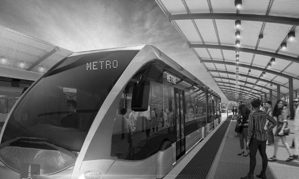 A black and white photo of a metro train at a station.