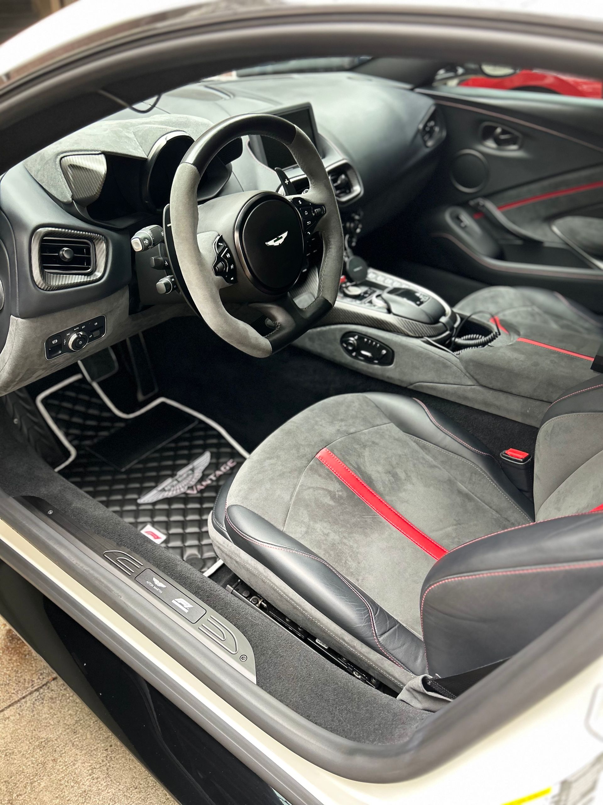 The interior of a black toyota tacoma is shown with the door open.