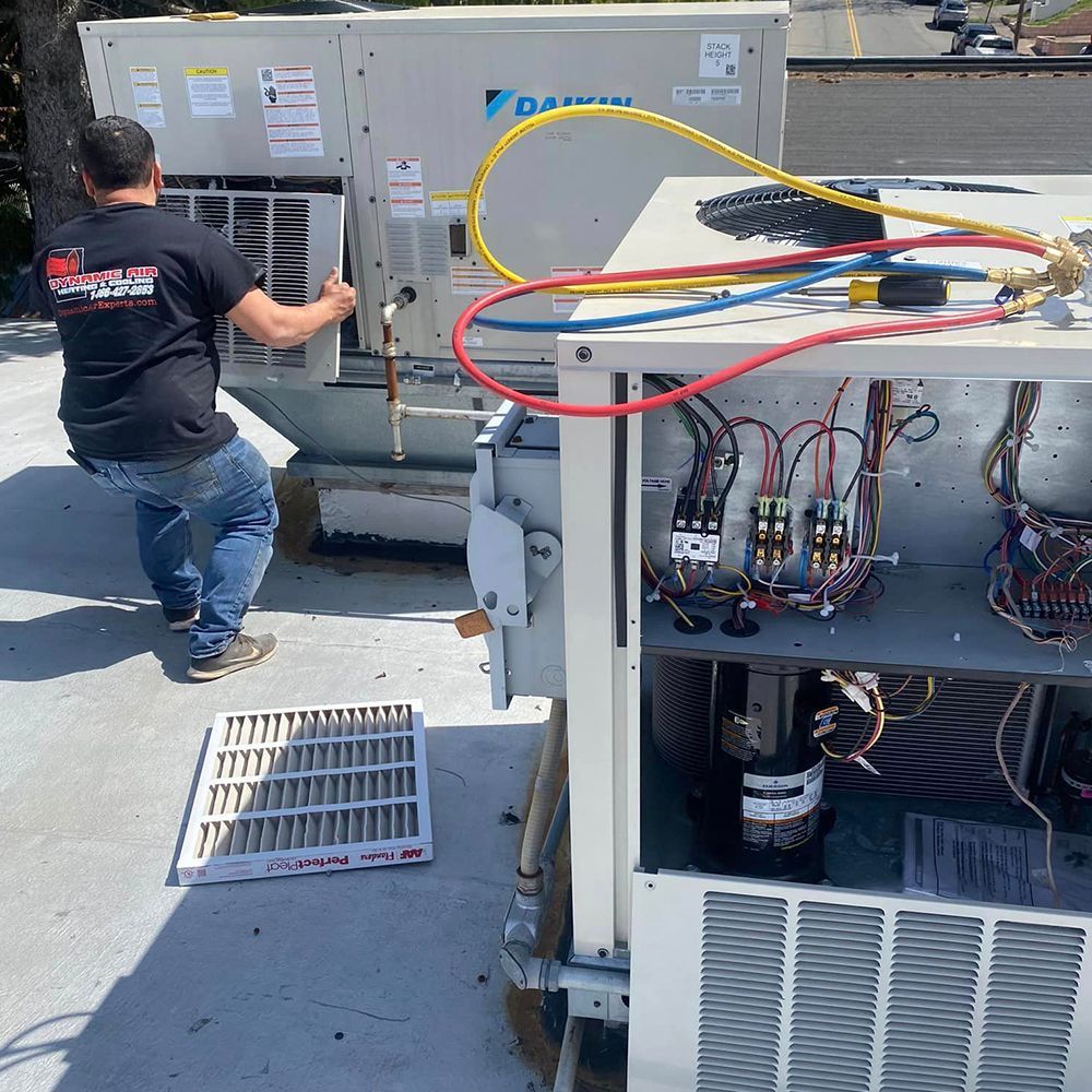 A man is working on a daikin air conditioner