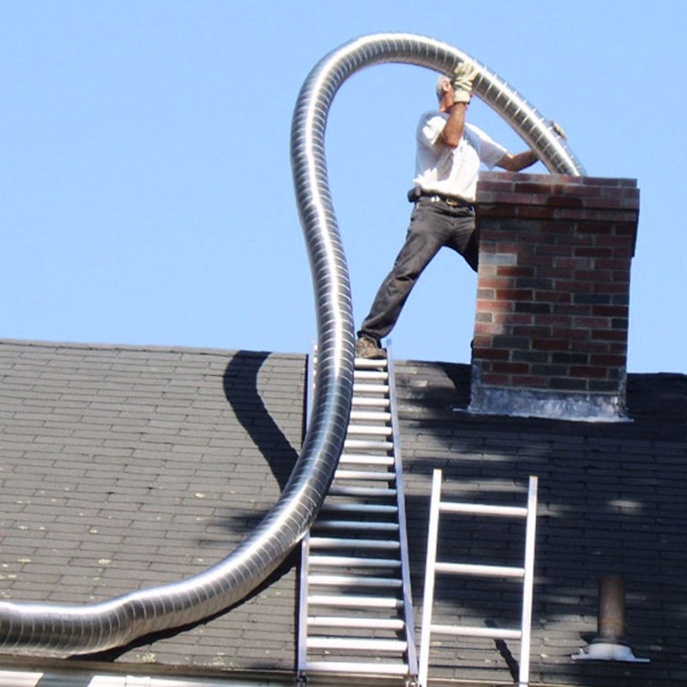 A man is working on a chimney on top of a ladder