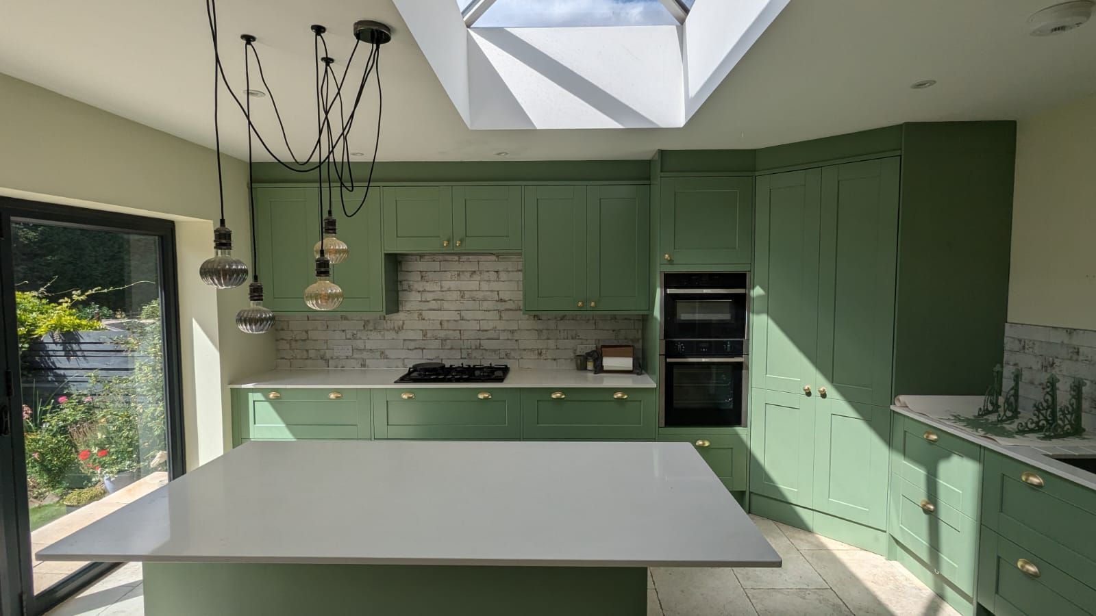 Spray painting green kitchen cabinets by Painters and decorators Leicester