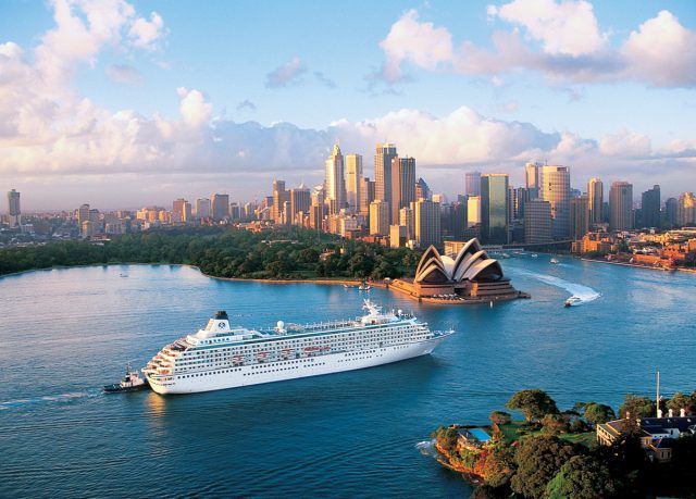 An aerial view of a cruise ship docked at a pier in the ocean.