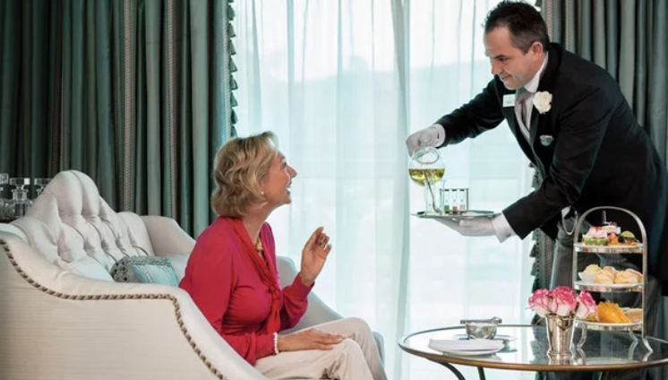 A group of cruise ships are docked in a harbor.