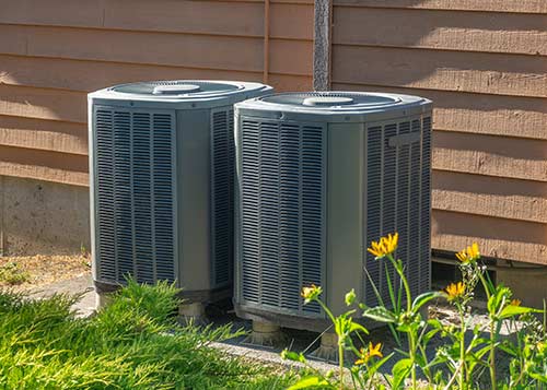 Heating & Ac Company — Electrician Repairing Air Conditioner Indoors in Pittsfield, MA