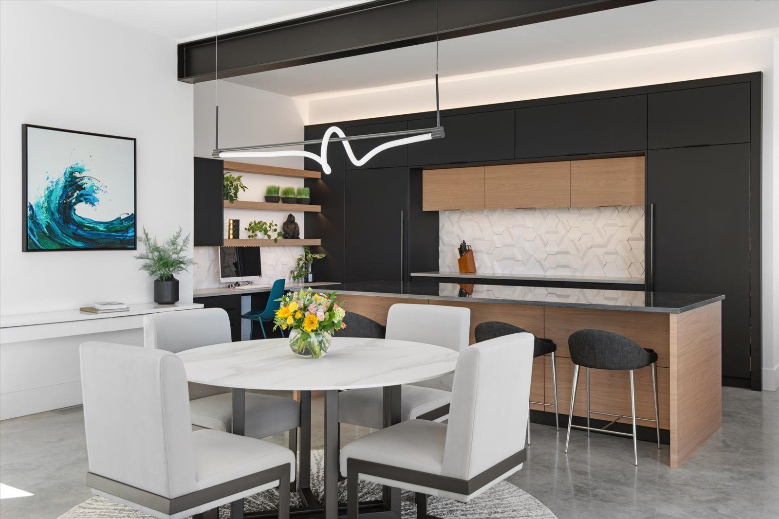 An artist 's impression of a kitchen and dining room with a round table and chairs.