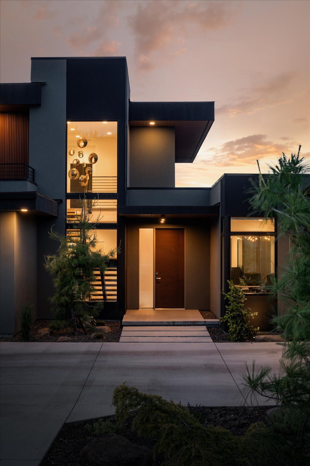 A modern house with a sunset in the background