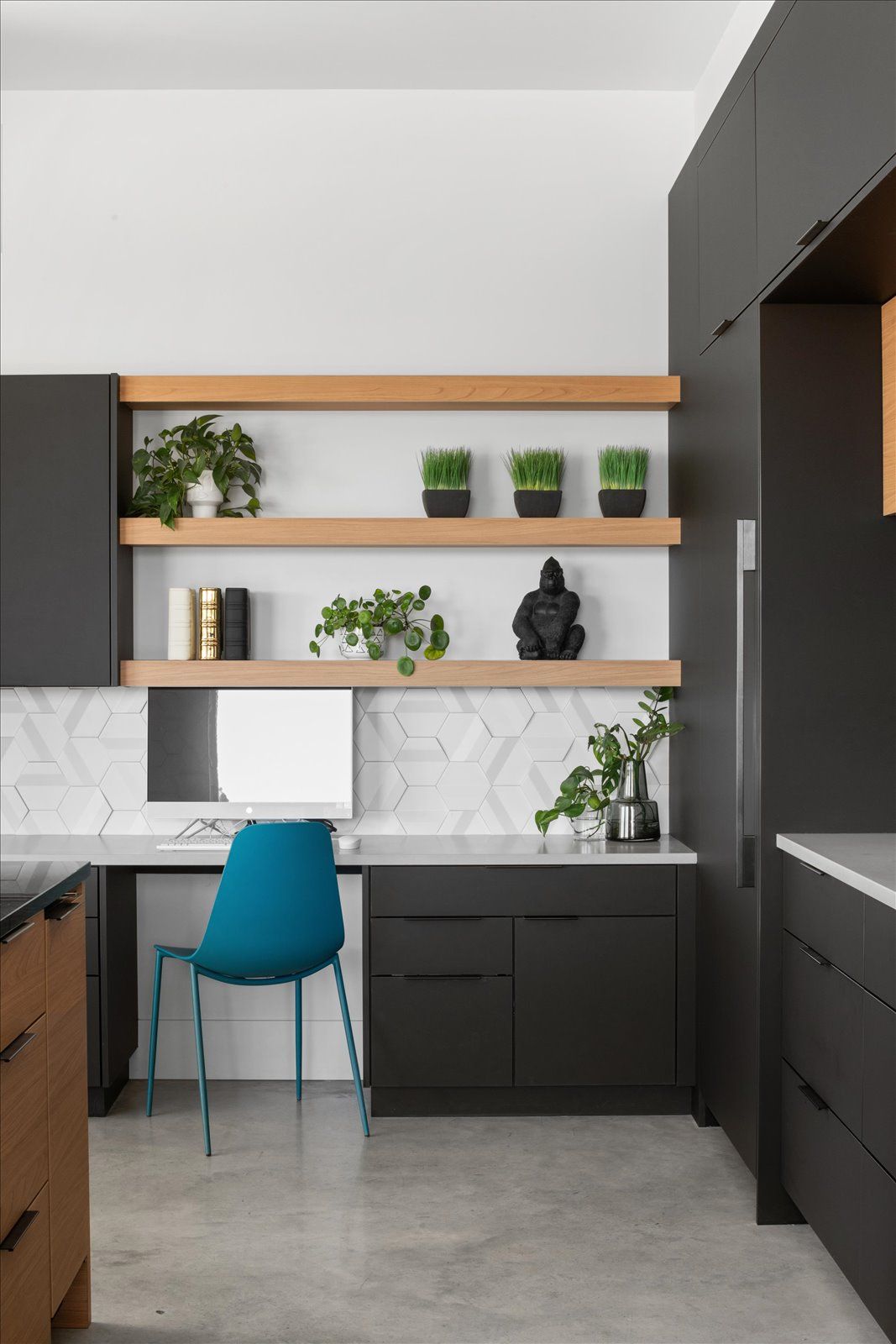A modern house with two garages and a driveway at sunset.