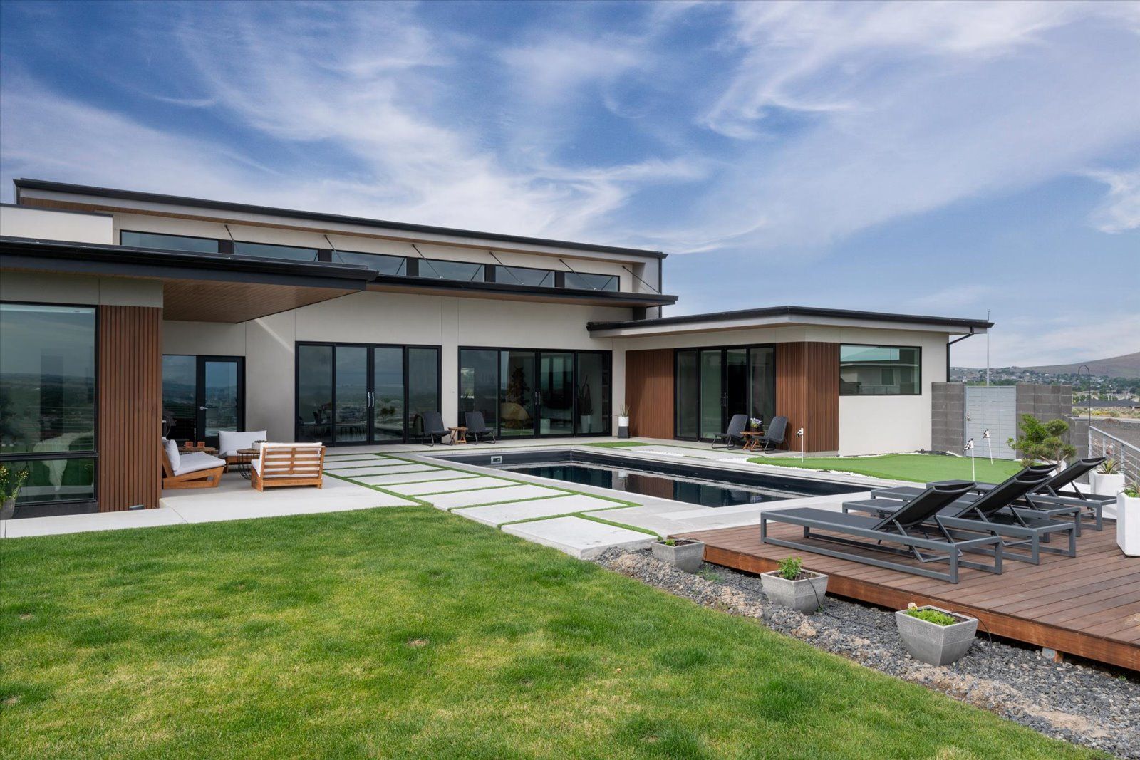 A large house with a swimming pool in the backyard.
