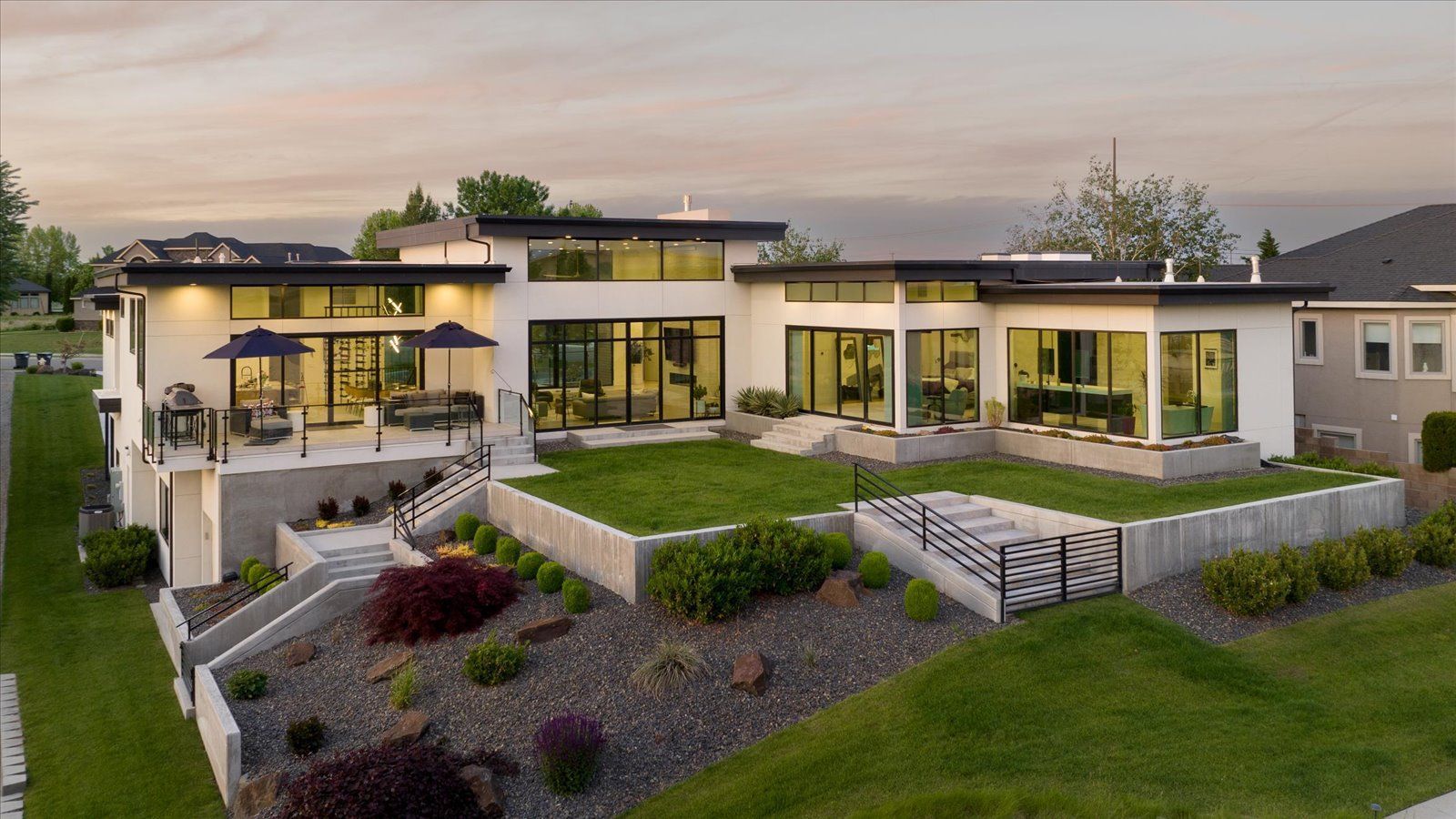 An aerial view of a large house with a lot of windows and a large lawn.