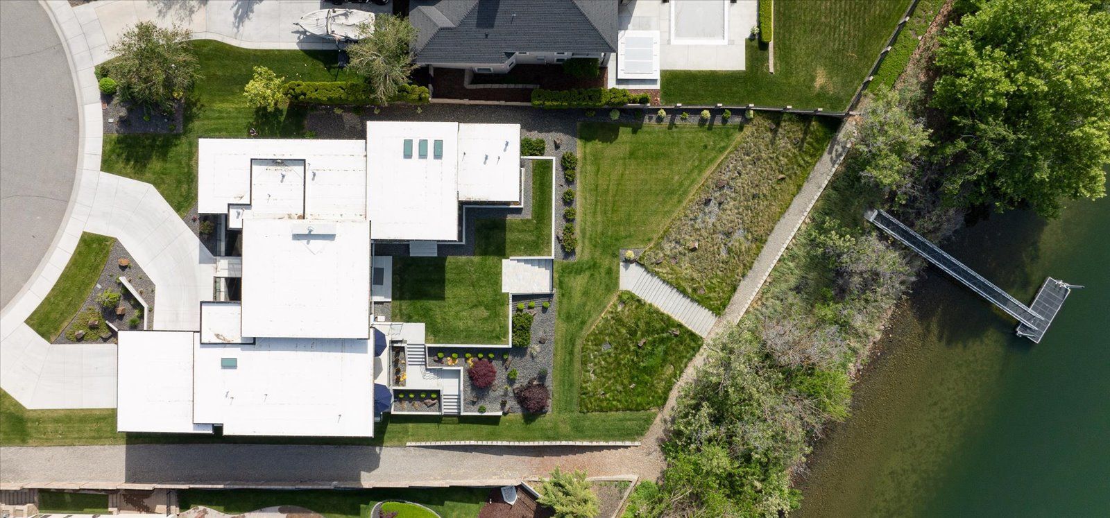 An aerial view of a house next to a body of water.