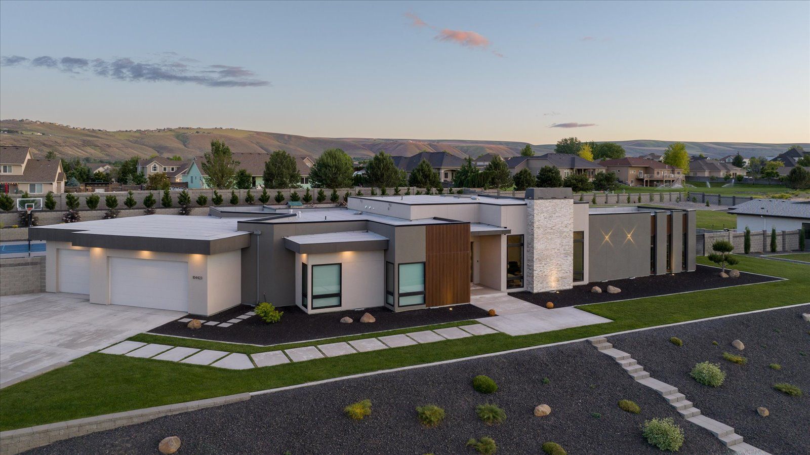 An aerial view of a modern house in a residential area