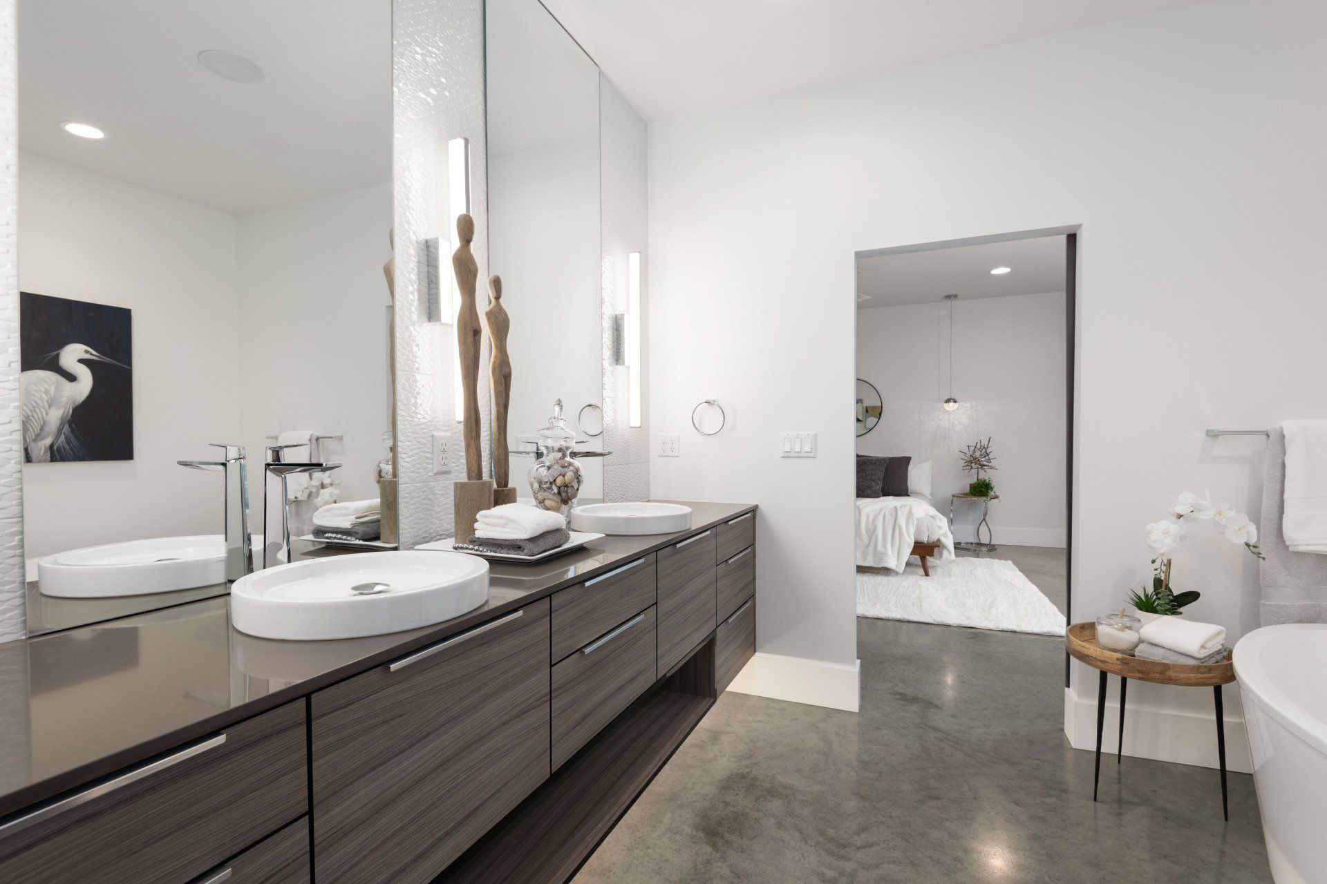 A bathroom with two sinks and a large mirror.