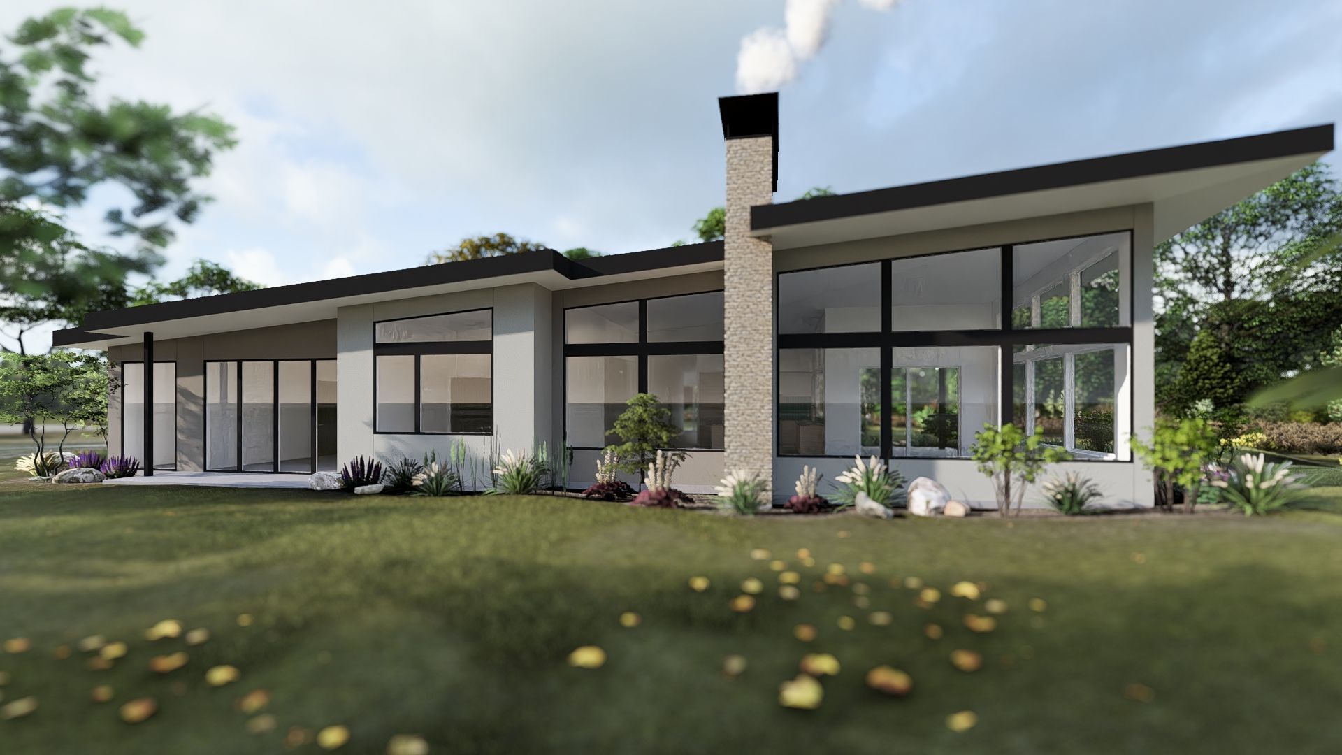 A modern house with a lot of windows is sitting on top of a lush green field.