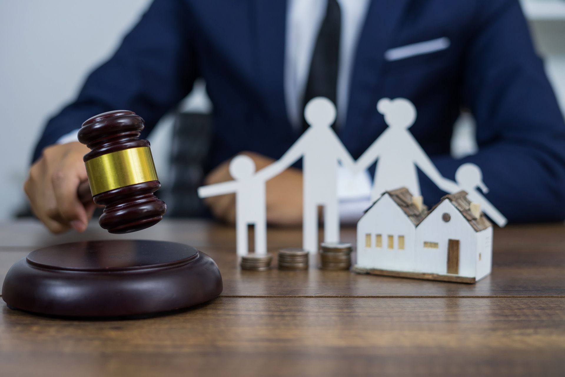 Family figure and gavel symbolizing legal support from a trusted local family law firm.