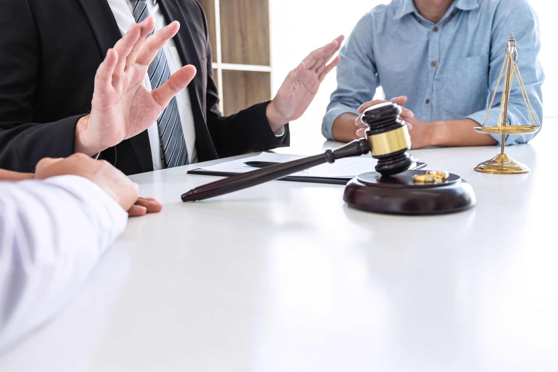Experienced family law attorney discussing divorce proceedings with a couple. Experienced family law attorney discussing divorce proceedings with a couple.