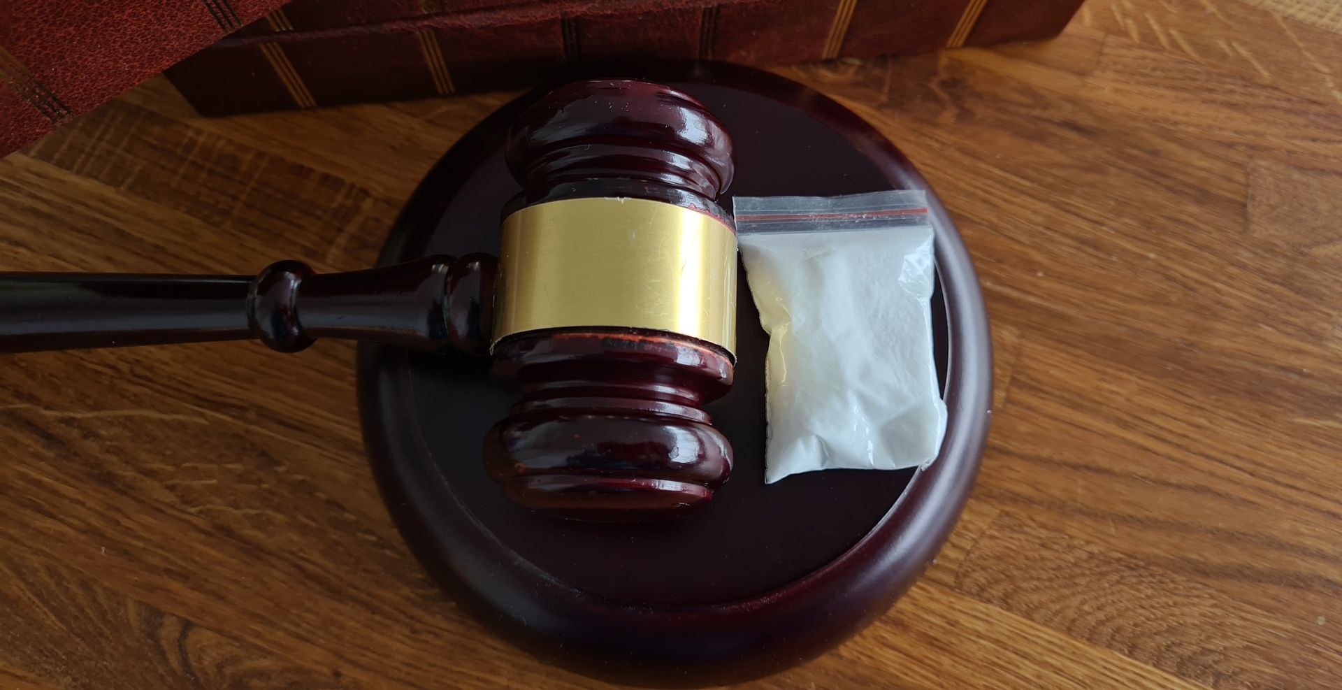 Heroin with gavel and scales of justice, symbolizing drug crime defense lawyer legal implications.