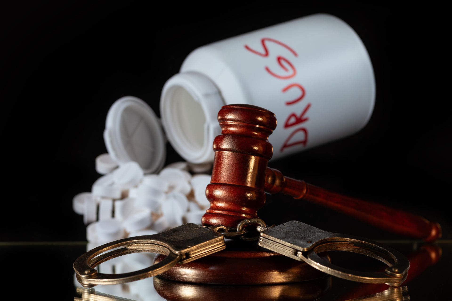 Handcuffs, Judge's Gavel, and Pills | Drug Crime Defense Lawyer | Monroe, MI 