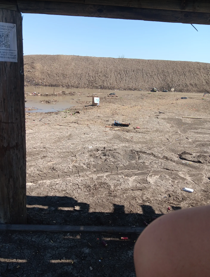 A sign on a wooden post says no parking